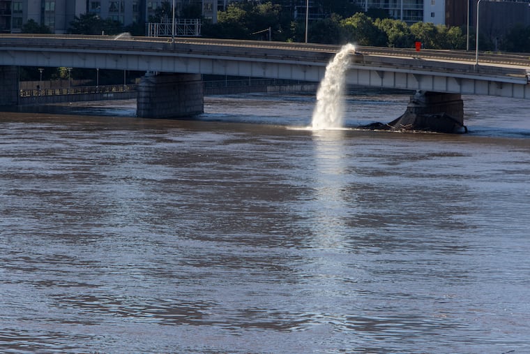 Water being pumped from the Vine Street Expressway into the Schuylkill on Friday.