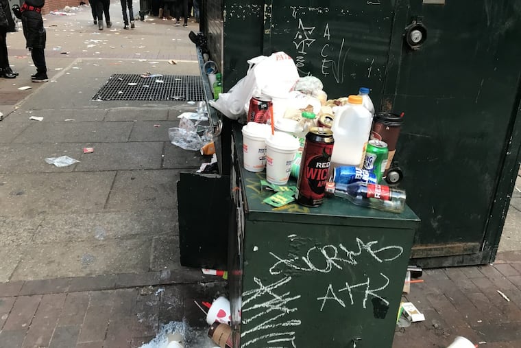 Trash still filled streets and sidewalks around City Hall in Philadelphia at rush hour Thursday evening as workers from the street department hustled to clean up after the Eagles Super Bowl parade. Roads could not be opened until the cleanup was finished. Thousands of fans who lingered didn't help matters.