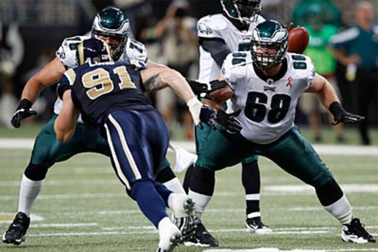 Eagles offensive linemen Todd Herremans (left) and Evan Mathis block for Michael Vick against the Rams. (Yong Kim/Staff Photographer)