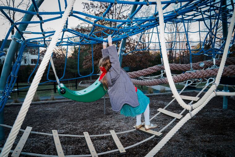 A child climbs a jungle gym at Spark Park in Leesburg, Va., on Dec. 19. MUST CREDIT: Maxine Wallace/The Washington Post