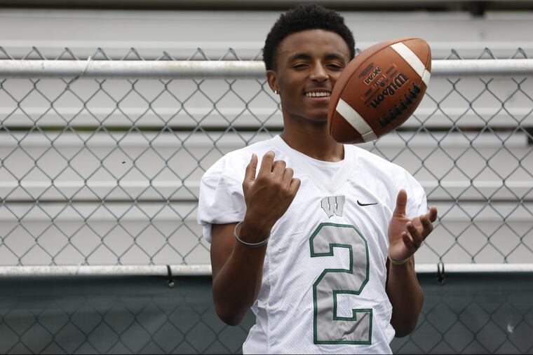 Donovan Bunch, 16, tosses a football on the sideline of the football field at Winslow Township High School in Winslow Township, NJ, on Monday, June 11, 2018. MAGGIE LOESCH / Staff Photographer