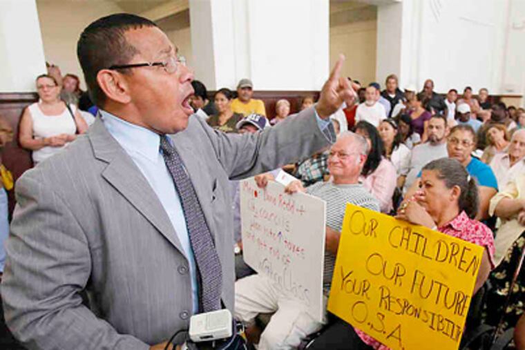 Before the Council hearing, community activist Angel Cordero (left) leads protesters angry over the sharp tax increases and a potential county takeover of policing in the city. (Akira Suwa / Staff Photographer)
