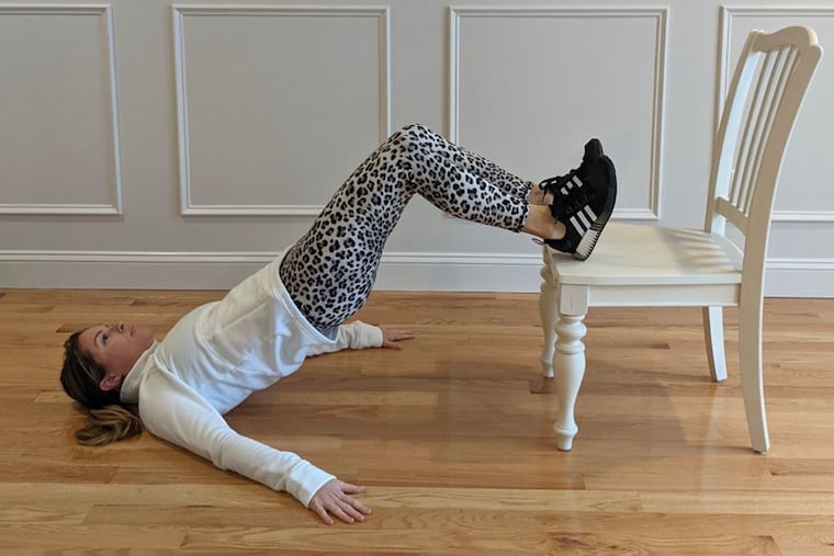 Ashley demonstrates an advanced glute bridge.