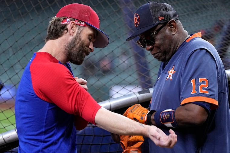 Phillies star Bryce Harper catches up with Astros manager Dusty Baker over the weekend in Houston.