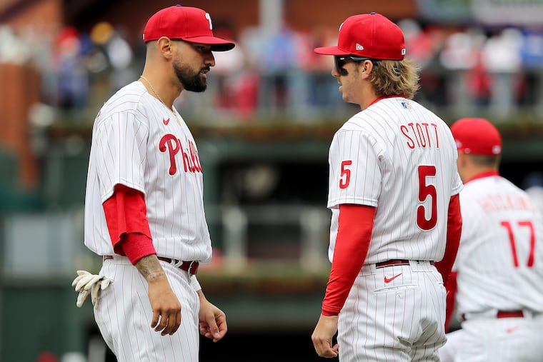 Nick Castellanos (left) tells Bryson Stott, typically a shortstop who is also playing third base, not to worry about making mistakes at his new position.