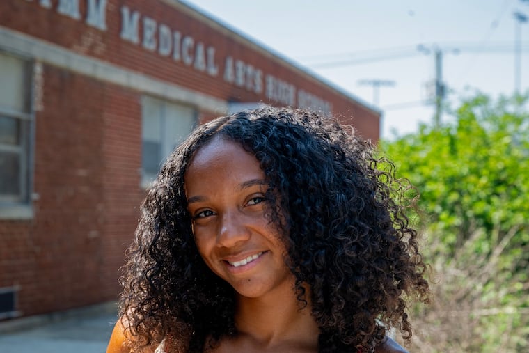 Jordan Hawkins poses outside her former, now-closed school, the Dr. Charles E. Brimm Medical Arts High School, Wednesday, Jun. 25, 2025. She spent her senior year learning virtually because of the pandemic. She just graduated from the University of Arizona, and plans to pursue a Master's degree