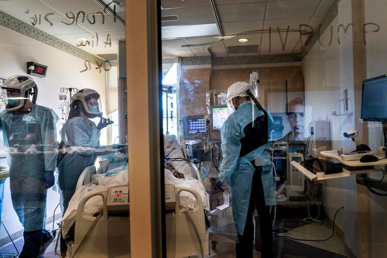 Nurses and respiratory specialists treat coronavirus patients at El Centro Regional Medical Center in California, with a doctor phoning in.