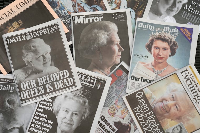 Newspapers devoted to the death of Queen Elizabeth II are seen in Manchester, England, Friday, Sept. 9, 2022. Queen Elizabeth II, Britain's longest-reigning monarch, died on Thursday Sept. 8 aged 96. (AP Photo/Jon Super)