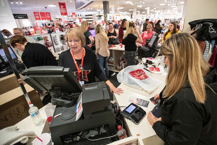 Terri Ross (left) checks out a customer at a store in the Huntington Mall on Nov. 25, 2022, in Barboursville, W. Va.