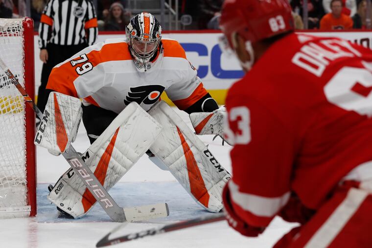 Carter Hart blocks a shot by Red Wings defenseman Trevor Daley in the second period.