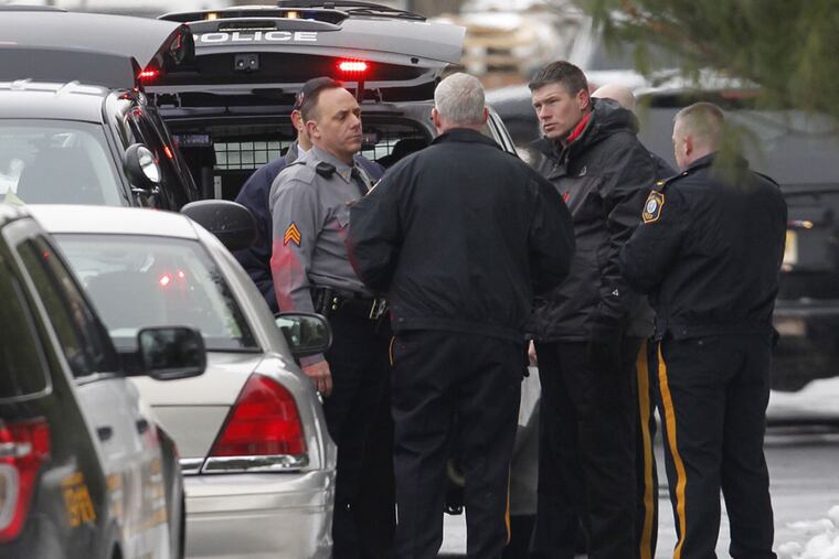 Law enforcement officials gather at the scene of a reported workplace shooting in Moorestown, Burlington County, N.J. Feb. 23, 2015. (Alejandro A. Alvarez / Staff Photographer)