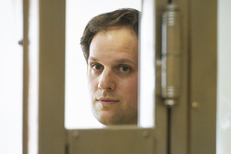 Wall Street Journal reporter Evan Gershkovich stands in a glass cage in a courtroom at the Moscow City Court in Moscow, Russia, in June.