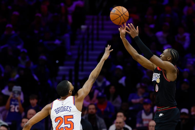 Sixers guard Tyrese Maxey shoots as Mikal Bridges of the Knicks guards him on Jan. 24.
