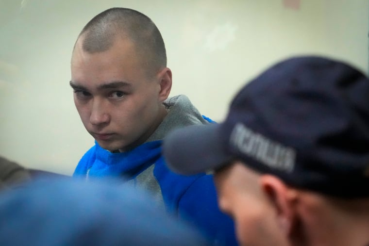 Russian army Sgt. Vadim Shishimarin, 21, is seen behind a glass during a court hearing in Kyiv, Ukraine, on Wednesday,
