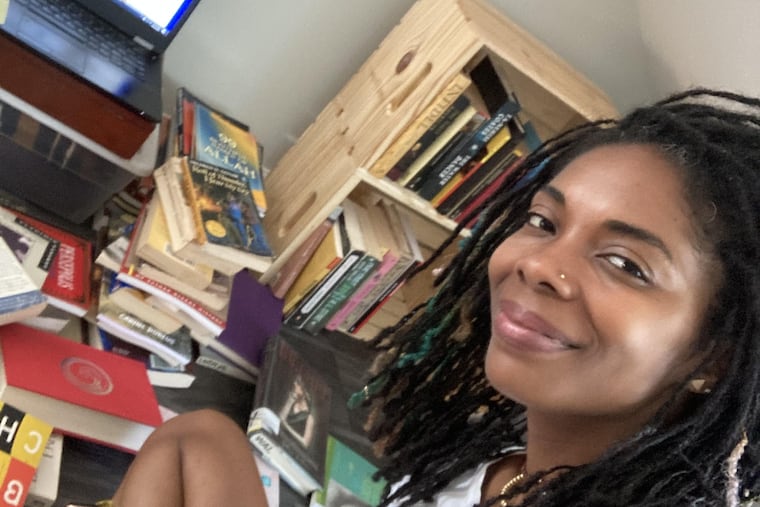 Philly teacher Shayla Amenra working on her laptop. With just days until the new school year begins — the first with full-time in-person education in 17 months — she is very anxious about heading back to the classroom.