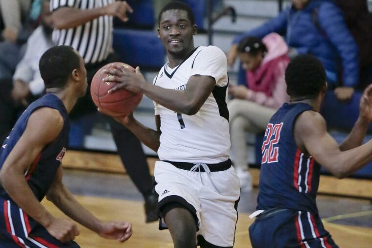 Mastery North’s Harold Daily splits Constitution’s Tyree Mitchell (left) and Abdul Riggins (right) during the Pumas’ win on Wednesday.