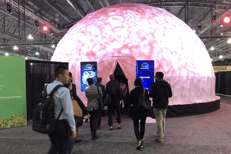 People line up to watch the film inside the BrainDome at the American Academy of Neurology meeting this week at the Pennsylvania Convention Center.