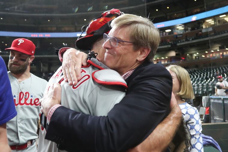 Phillies managing partner John Middleton hugs Phillies catcher J.T. Realmuto after the Phils beat the Houston Astros to clinch a playoff berth.