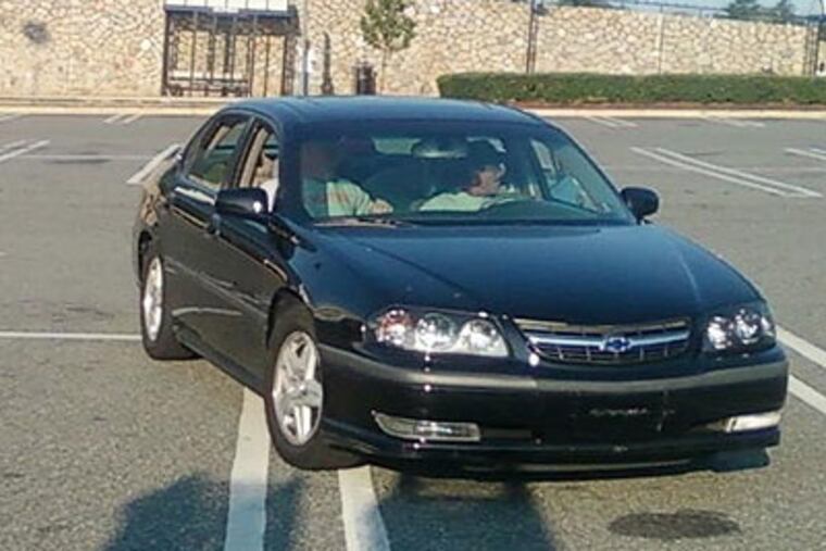 At least two workers were physically assaulted with baseball bats, but one of the victims was able to use his cell phone to photograph the suspects and their car. (Image released by Upper Merion Township police)