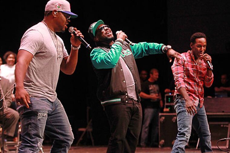 Boyz II Men, from left to right, Nate Morris, Wayna Morris and Shawn Stockman, perform a concert for the students of the Philadelphia High School for the Creative and Performing Arts on Tuesday afternoon. ( MICHAEL BRYANT / Staff Photographer )