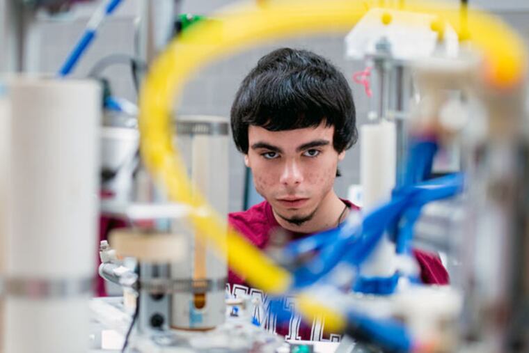 Justin Miniello, a student at North Montco Technical Career Center, works on an automated manufacturing machine prototype at the second ManuFest at Souderton High School on March 28, 2015. (JEFF FUSCO/For the Inquirer)