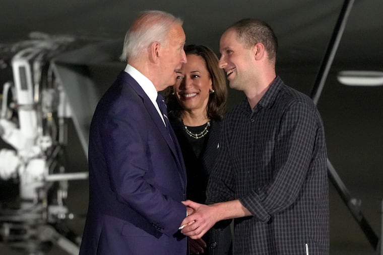 President Joe Biden, from left, and Vice President Kamala Harris greet reporter Evan Gershkovich at Andrews Air Force Base, Md., following his release as part of a 24-person prisoner swap between Russia and the United States, Aug. 1.