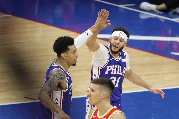 Danny Green (left) congratulated Seth Curry after a three-pointer against the Hawks during Game 2.