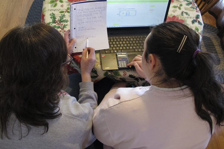 An Ohio cyber school student with her mother. (AP Photo/Kantele Franko)