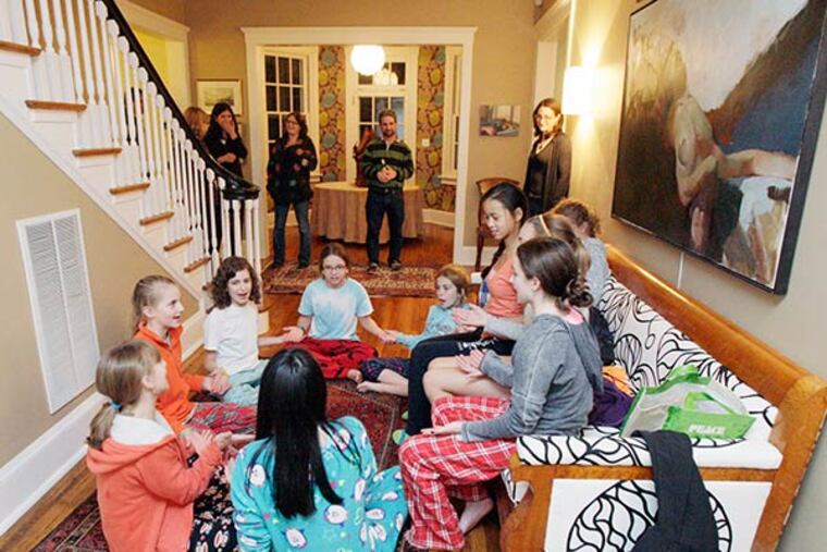 Parents arrive to pick up their girls and wait as they play a game during the sleepunder at the Gorman's home in Elkins Park on October 25, 2013. ( ELIZABETH ROBERTSON / Staff Photographer )