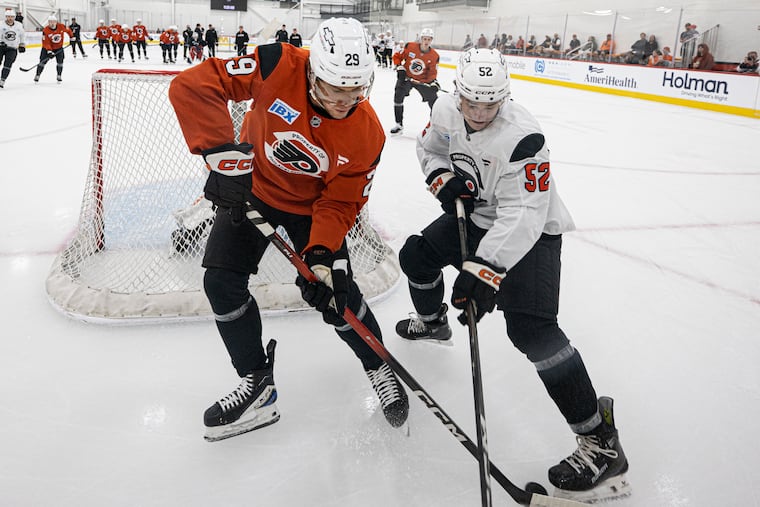 Nikita Grebenkin (left) and Denver Barkey compete for the puck during Flyers rookie camp on Monday.