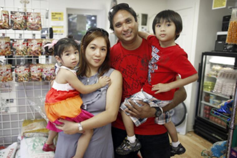 Rowena and Hyen David with their children, Ivana and Ryan, in the Philly-Pinoy store in Bridgeport. (Laurence Kesterson / Staff Photographer)