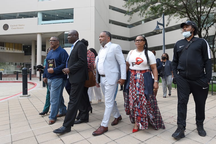 Attorney Ben Crump, second from left, walks with Ron Lacks, left, Alfred Lacks Carter, third from left, both grandsons of Henrietta Lacks, and other descendants of Lacks, outside the federal courthouse in Baltimore in 2021.