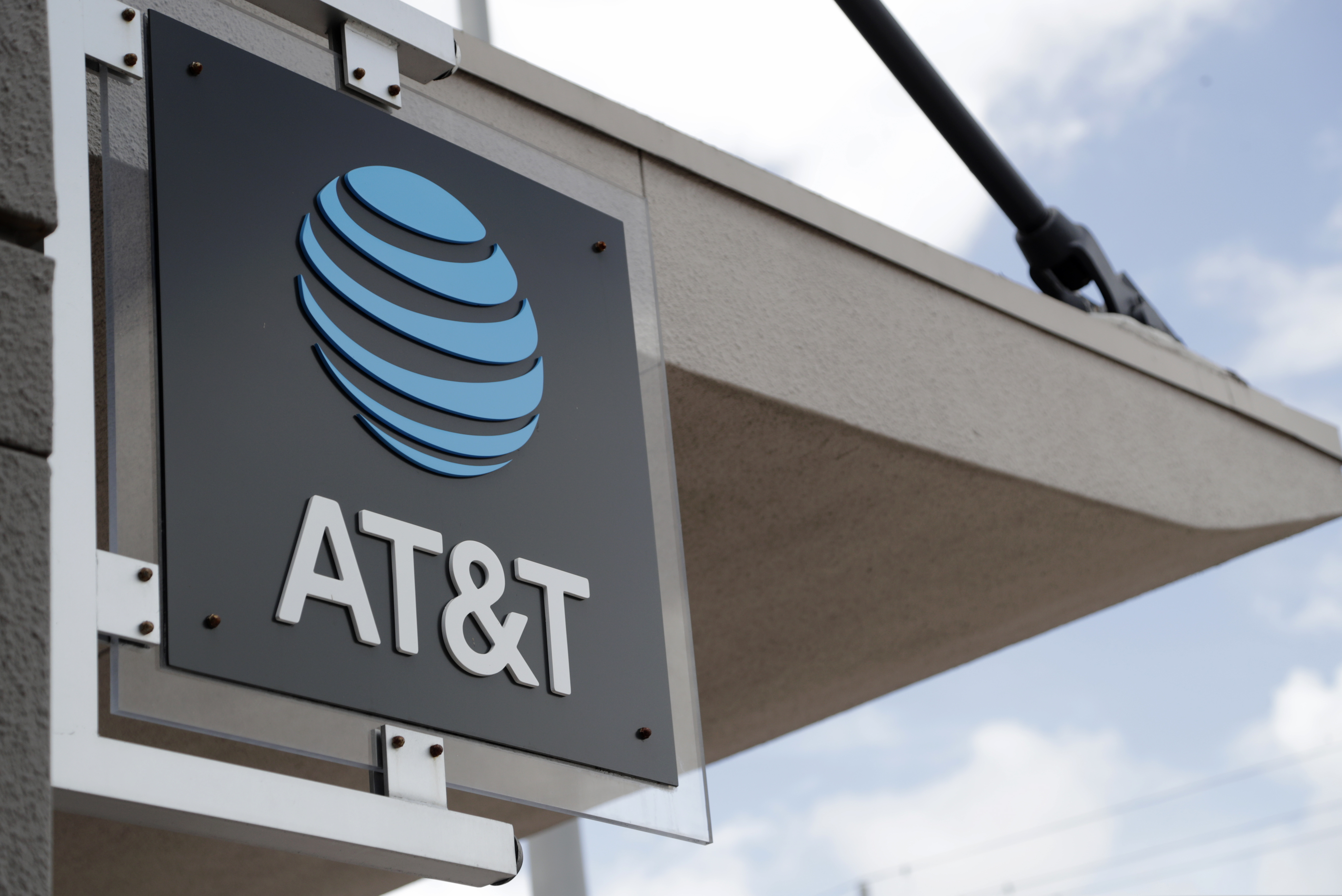 In this July 18, 2019 photo, a sign is displayed at an AT&T retail store in Miami. Activist hedge fund manager Elliott Management is making a new $3.2 billion investment in AT&T, saying the company could be valued at more than $60 a share by 2021's end. AT&T stock jumped nearly 6% but then fell back. (AP Photo/Lynne Sladky, File)