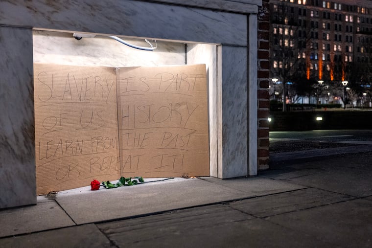 A single rose and a handwritten cardboard sign (“Slavery is part of U.S. history learn from the past or repeat it”) are inside an empty hearth at the President’s House site in Independence National Historical Park late Thursday, Jan. 22, 2026 after workers removed display panels about slavery.