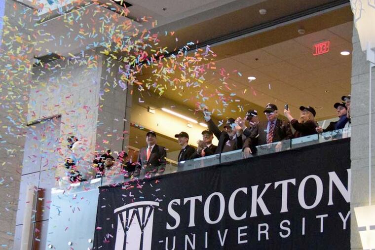 A cloud of confetti greets the official naming of Stockton University at a campus celebration in Pomona, N.J., on Wednesday. The 44-year-old school has broken enrollment records four years in a row.