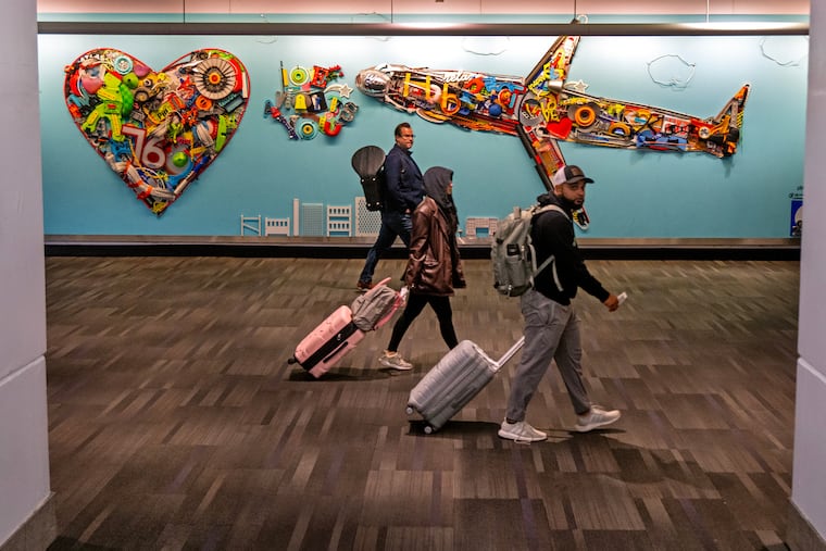 “Love Awaits You” artwork by Philadelphia artist Terrance Woolford in the Terminal B Baggage Claim at Philadelphia International Airport on Nov. 9, 2025. The artist is known for using recycled, trash-picked objects as a source of inspiration.