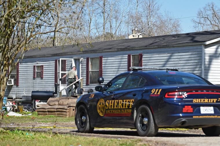 Investigators work the scene of a shooting Saturday in Ascension Parish, La. Authorities says five people were murdered by Dakota Theriot in two parishes.