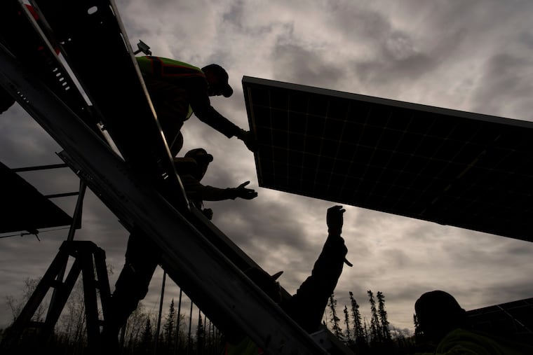 Workers install panels at a solar project May 21, 2025, in Galena, Alaska.