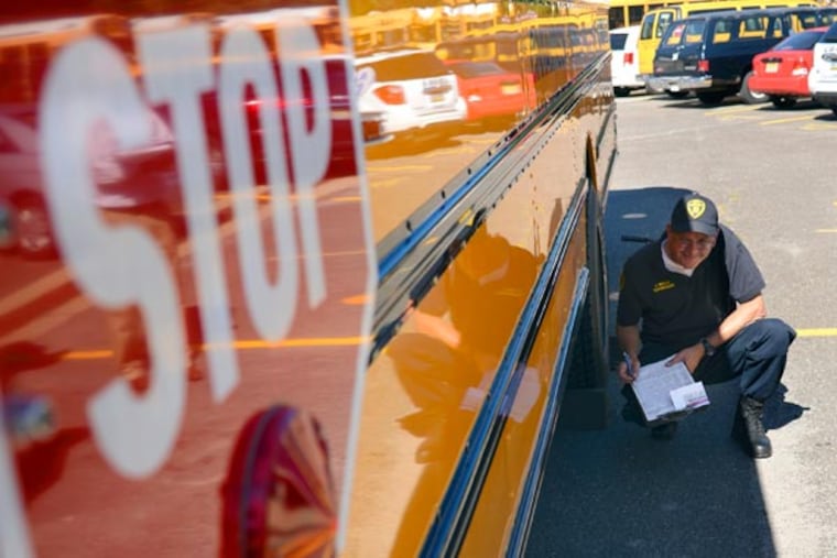 New Jersey Motor Vehicle Commission School Bus Inspection Unit mobile inspector/supervisor Jim WIlls fills out his report on a school bus during a regularly scheduled inspection at the Cinnaminson Board of Education Transportation's high school yard September 4, 2013. The MVU invited the press to watch the inspection to reinforce the importance of the state's stringent school bus inspection program that examines 24,000 student transportation vehicles twice a year. ( TOM GRALISH / Staff Photographer )
