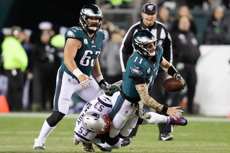 Eagles quarterback Carson Wentz getting sacked by the Patriots' Kyle Van Noy in last week's 17-10 loss. He was sacked a season-high five times.
