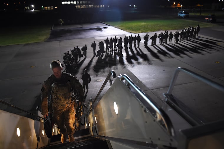 U.S. Army personnel board a plane for a deployment to Afghanistan from Fort Campbell, Ky., in November 2014.