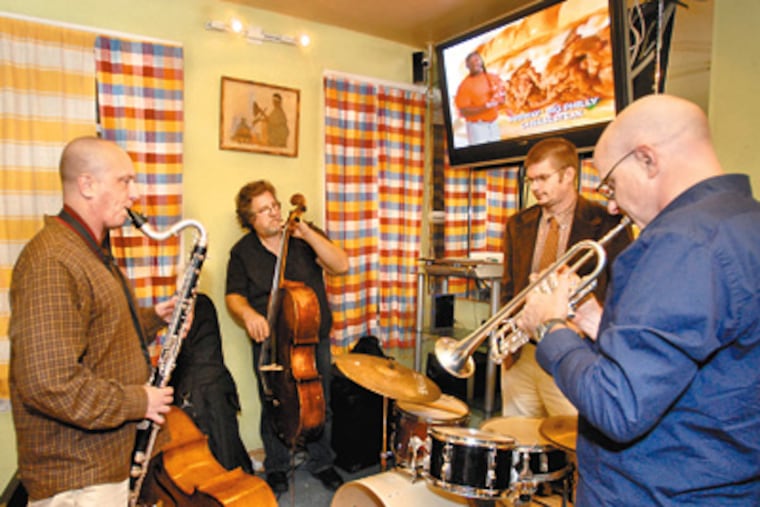 Philly’s Sonic Liberation Front, an Afro-Cuban group with Terry Lawson on bass clarinet and Todd Margasak on trumpet, plays at Gojjo. “The energy is always happening,” says a series organizer. (Bob Williams/For the Inquirer)