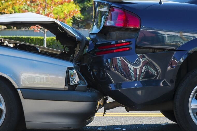 Auto accident involving two cars on a city street