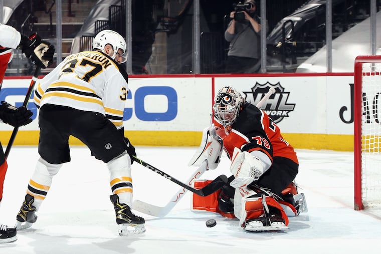 The Bruins' Patrice Bergeron scores a power-play goal 31 seconds into overtime against the Flyers' Carter Hart.