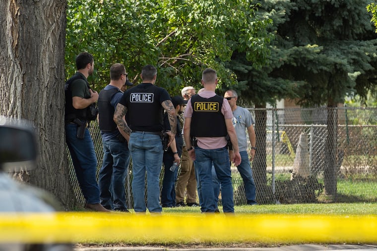 Law enforcement personnel investigate after an ICE agent fatally shot a man in the Franklin Park suburb of Chicago on Sept. 12.