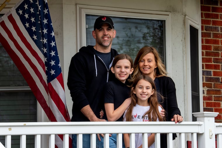 Jason and Corrin DeMent and their daughters Natalee (left), 12, and Adilynn (right), 10, pose for a photo on the porch of their Haddon Township home March 25, 2020. They fear losing everything after the governor ordered the closure of their South Jersey fitness center as part of the coronavirus stay-at-home edict in New Jersey.