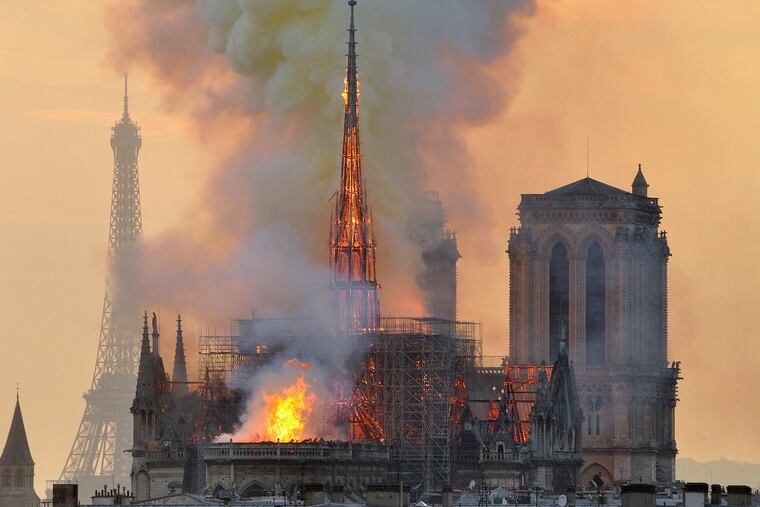 Flames and smoke rise from the blaze at Notre Dame Cathedral in Paris that destroyed its spire and its roof but spared its twin medieval bell towers. Some bristle at rebuilding efforts in the wake of poverty.