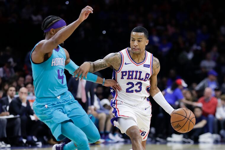 Sixers guard Trey Burke dribbles the basketball against Charlotte Hornets guard Devonte' Graham during the first-quarter on Sunday, November 11, 2019 in Philadelphia.