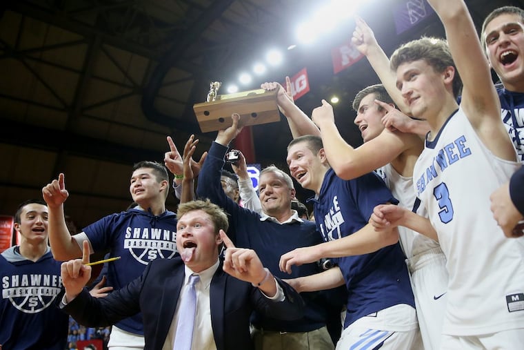 Shawnee head coach Joe Kessler and his players celebrate with the trophy after the Group 4 state championship game against Newark East Side at the Louis Brown Athletic.