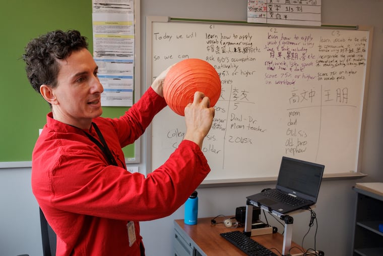 Michael A. Nusbaum uses a lantern during a recent Mandarin language class at Brimm Medical Arts High School at Camden High School.